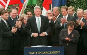WASHINGTON, : US President Bill Clinton smiles and invited dignitaries look on after signing a ratification document for enlargement of the North Atlantic Treaty Organization(NATO) in ceremonies at the White House in Washington, DC. In signing the document, the President officially granted approval for admitting Hungary, Poland and the Czech Republic to the NATO alliance. AFP PHOTO/Paul J. RICHARDS (Photo credit should read PAUL J. RICHARDS/AFP via Getty Images)